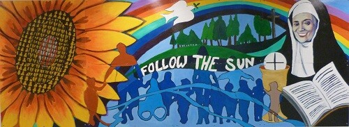 A mural picturing a sunflower, trees, people, and St. Julia